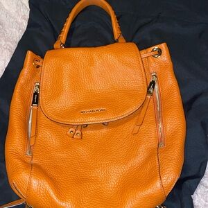 Michael Kors burnt orange backpack with gold hardware